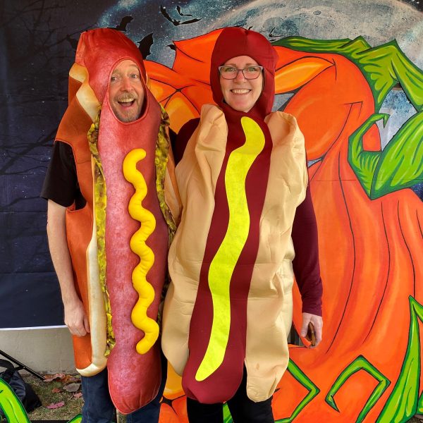 two people dressed as hot dogs pose togehter.