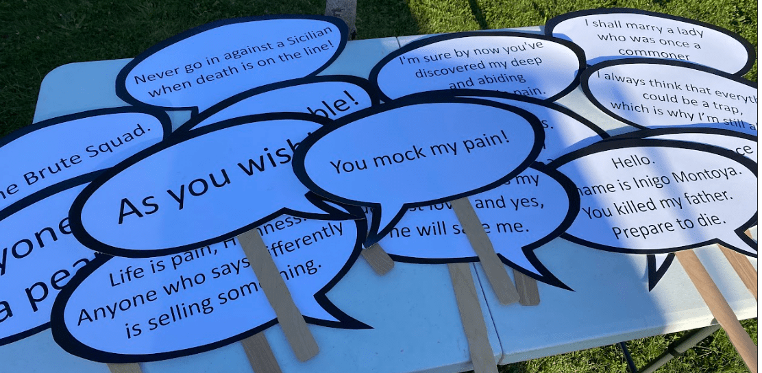 A collection of movie quotes on sticks for the photo booth