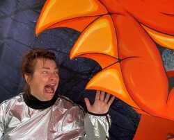 a woman screams as the jaws of the Halloween pumpkin threaten to crush her.