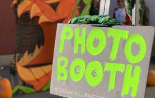 A sign that reads Photo Booth, with the scary Great Pumpkin in the background.