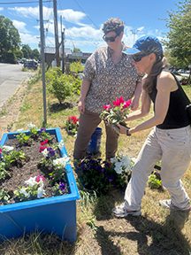 Two people planting a planter